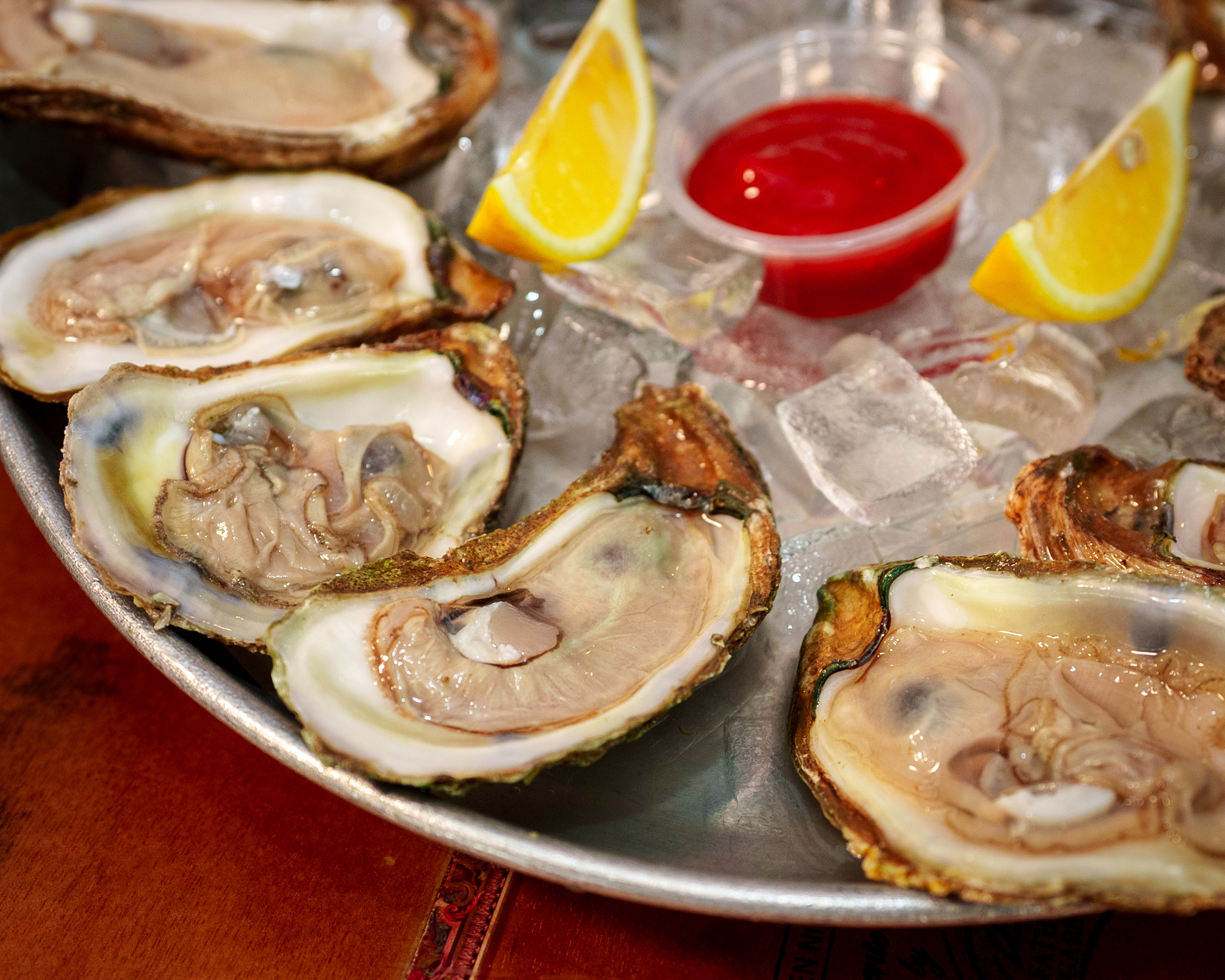 Fresh oysters on the half shell served on ice with lemon and cocktail sauce
